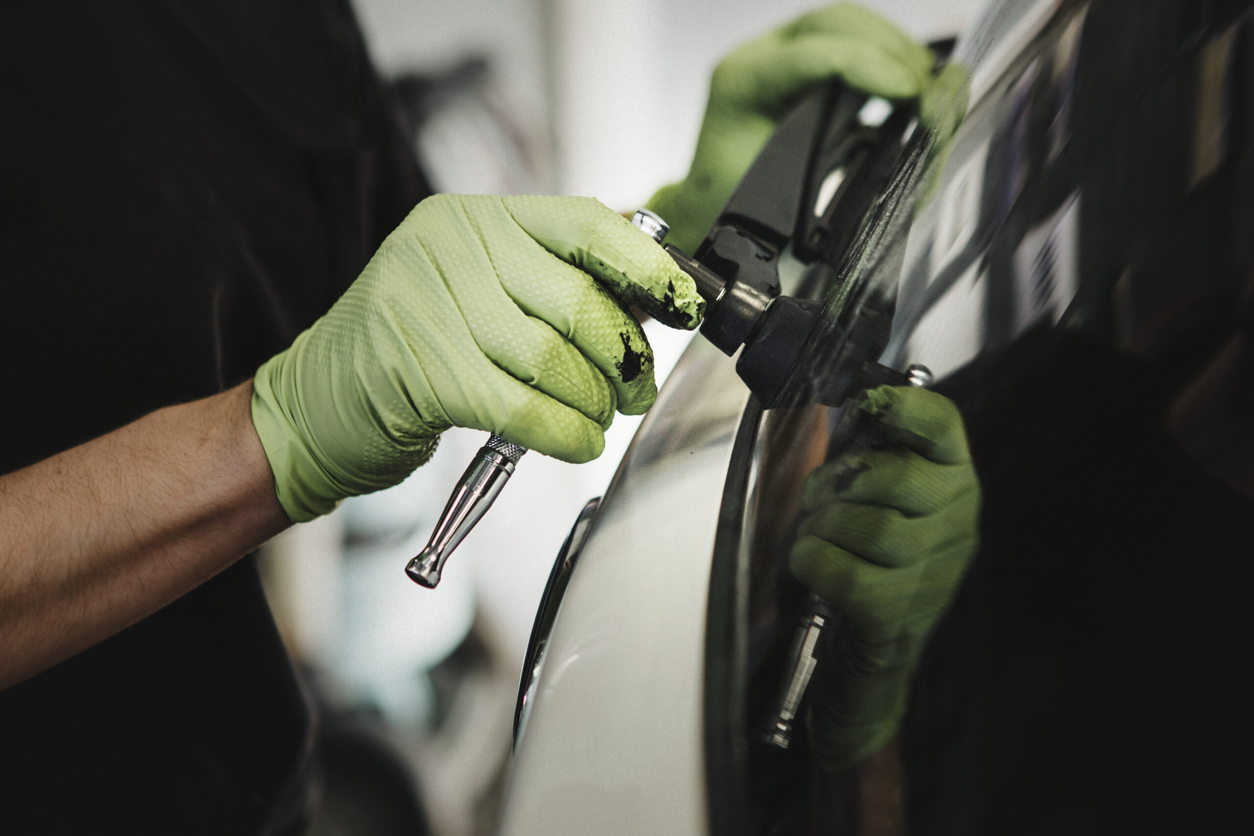 Mechanic removing car wiper arm