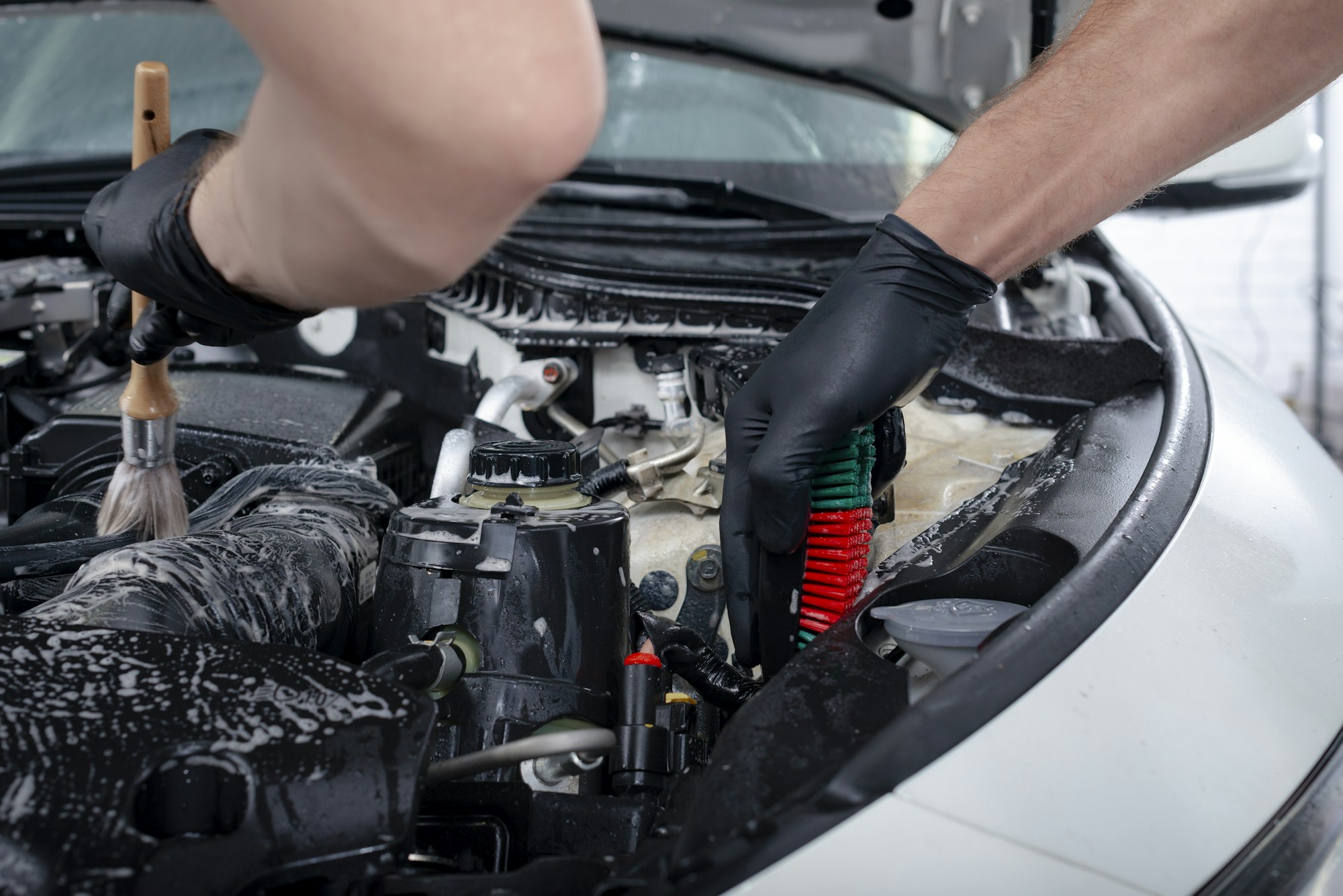 car-detailing-maintenance-cleaning-engine-with-the-foam-and-a-brush.jpg