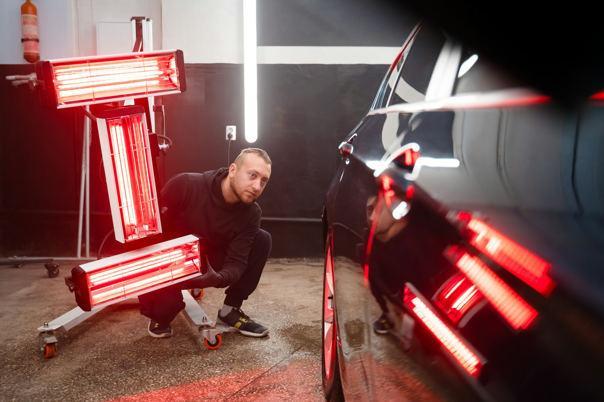 detailing-worker-with-infrared-lamps-near-the-car-car-detailing-concept.jpg